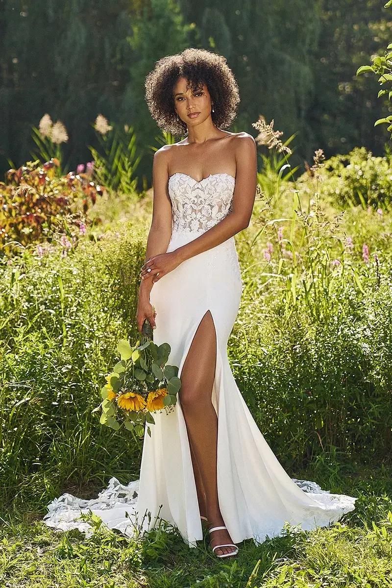 Model wearing a white gown by Lillian West